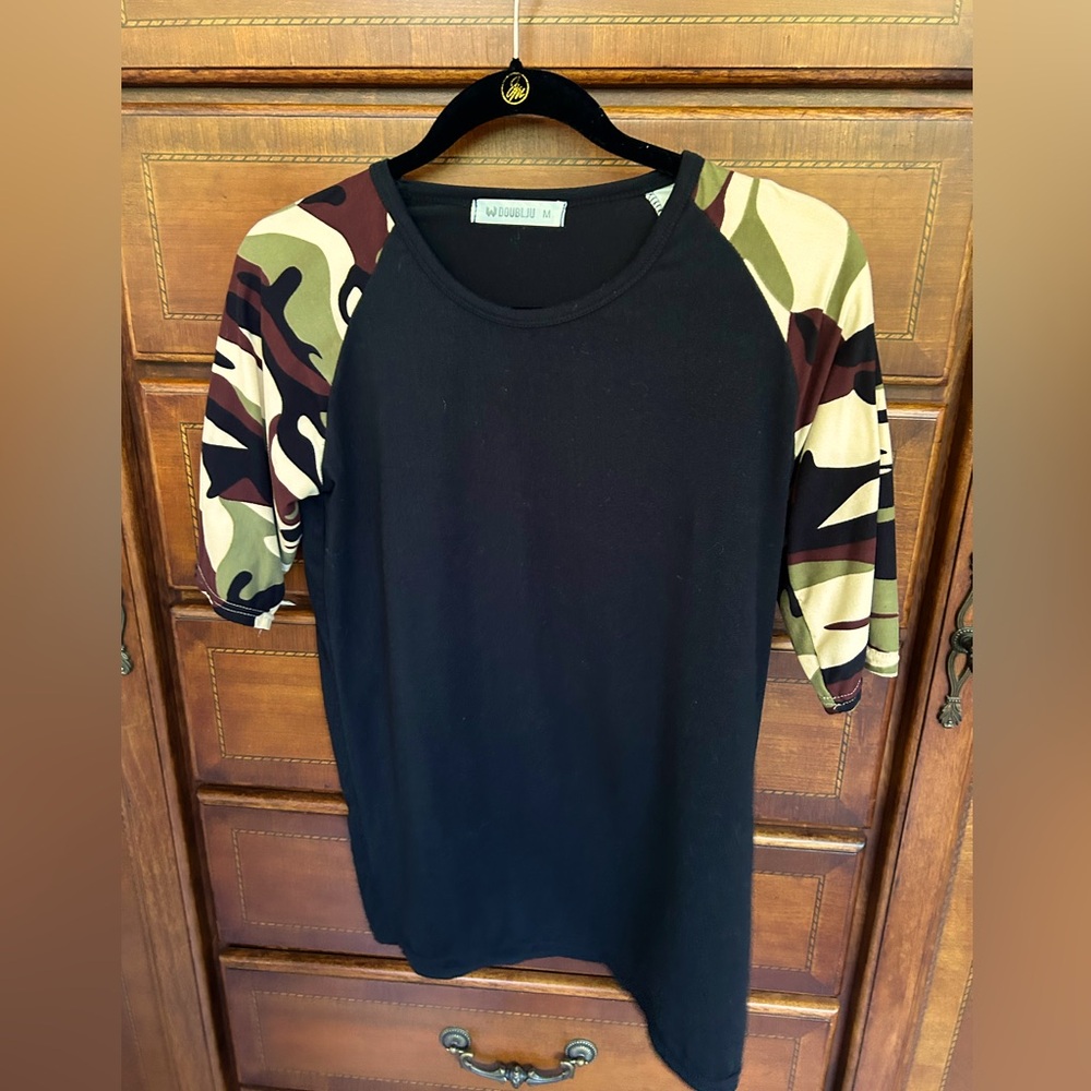 Camo and black top with elbow length sleeves.